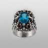 BigBlackMaria Potion ring from silver set with blue topaz and garnet up straight view.
