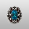 BigBlackMaria Potion ring from silver set with blue topaz and garnet front view.