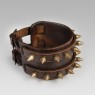 Leather bracelet with brass studs.