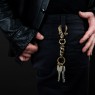 STS brass key chain skull design on male model.