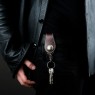 Oz Abstract Tokyo brown leather key holder on male model.
