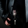 Oz Abstract Tokyo brown leather key holder on male model.