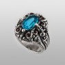 BigBlackMaria Potion ring from silver set with blue topaz and garnet left view.