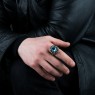 BigBlackMaria Potion ring from silver set with blue topaz and garnet on male model.