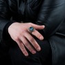 BigBlackMaria Potion ring from silver set with blue topaz and garnet on male model.
