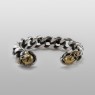 Solid Traditional Silver STS silver and brass skull bangle bracelet BR10 front view.