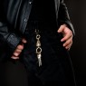 Solid Traditional Silver STS brass skull key chain KE08 on male model.