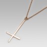 Reversed gold cross necklace.