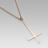 Reversed gold cross necklace.