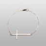 Thin gold cross bracelet.